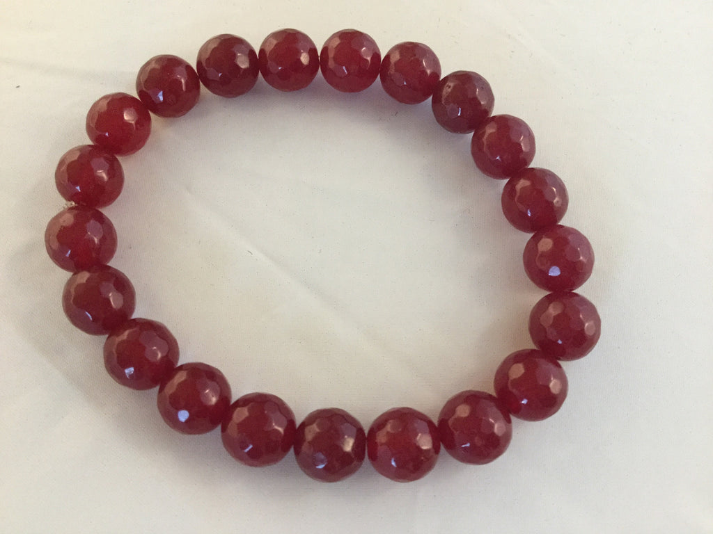 BR1S is a stretch bracelet with 8mm faceted red Rubies.