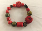 BR3S combines green Agate with large pieces of red Bamboo, Jasper, smokey Quartz and bronze coloured metal fancy inserts.