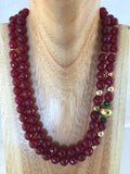 8mm faceted 2 string 8mm Rubies with gold inserts and emeralds.