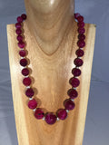 CLARET: large faceted fire Agate balls in descending size with Sterling inserts and clasp.