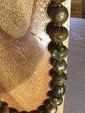 Rhyolite with African gold metal 15mm balls.